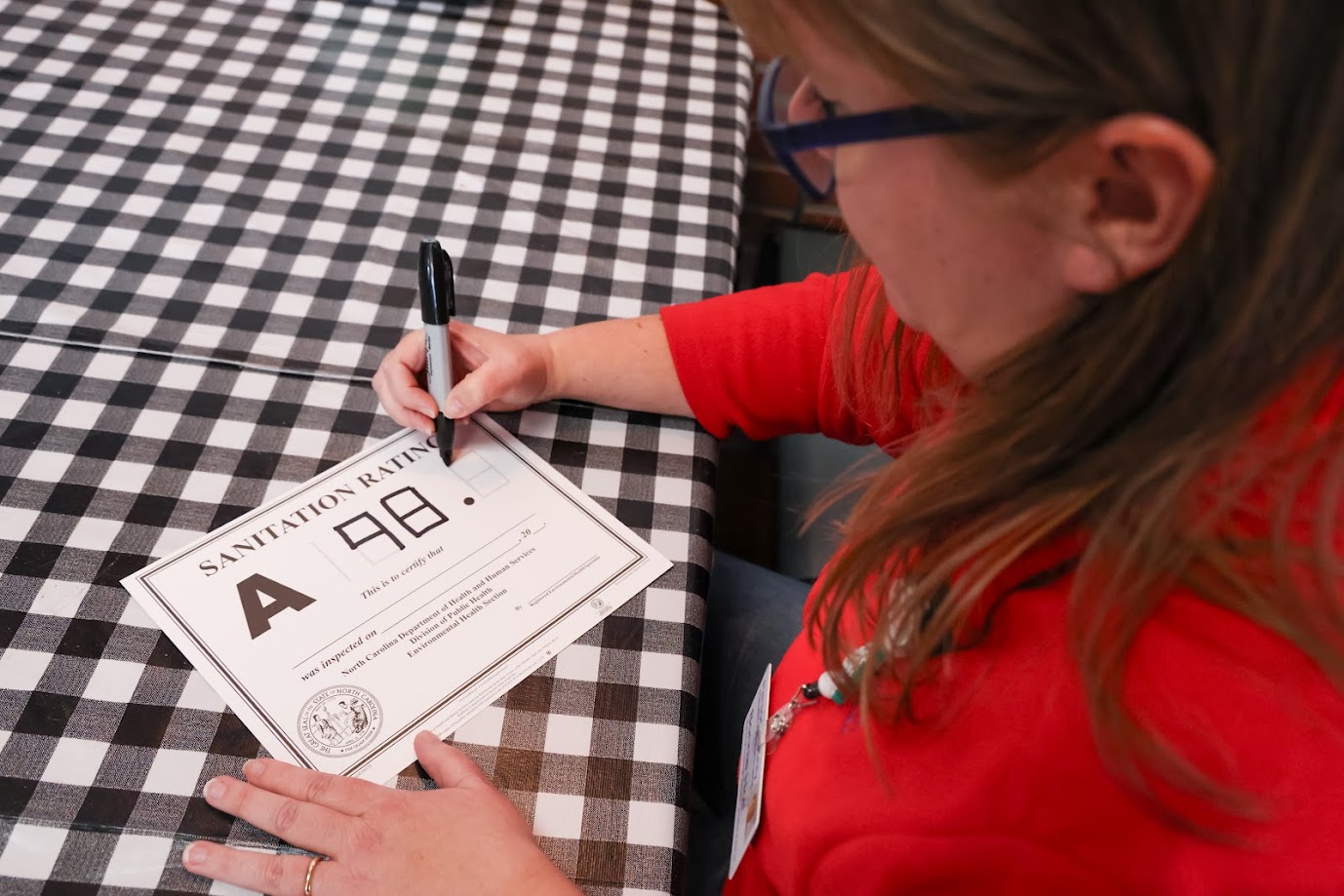 woman writing sanitation score