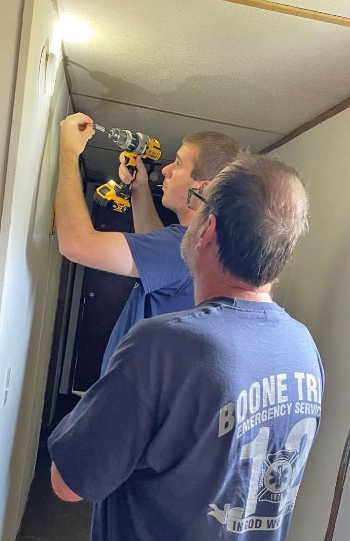 Boone Trail firefighters installing smoke alarms