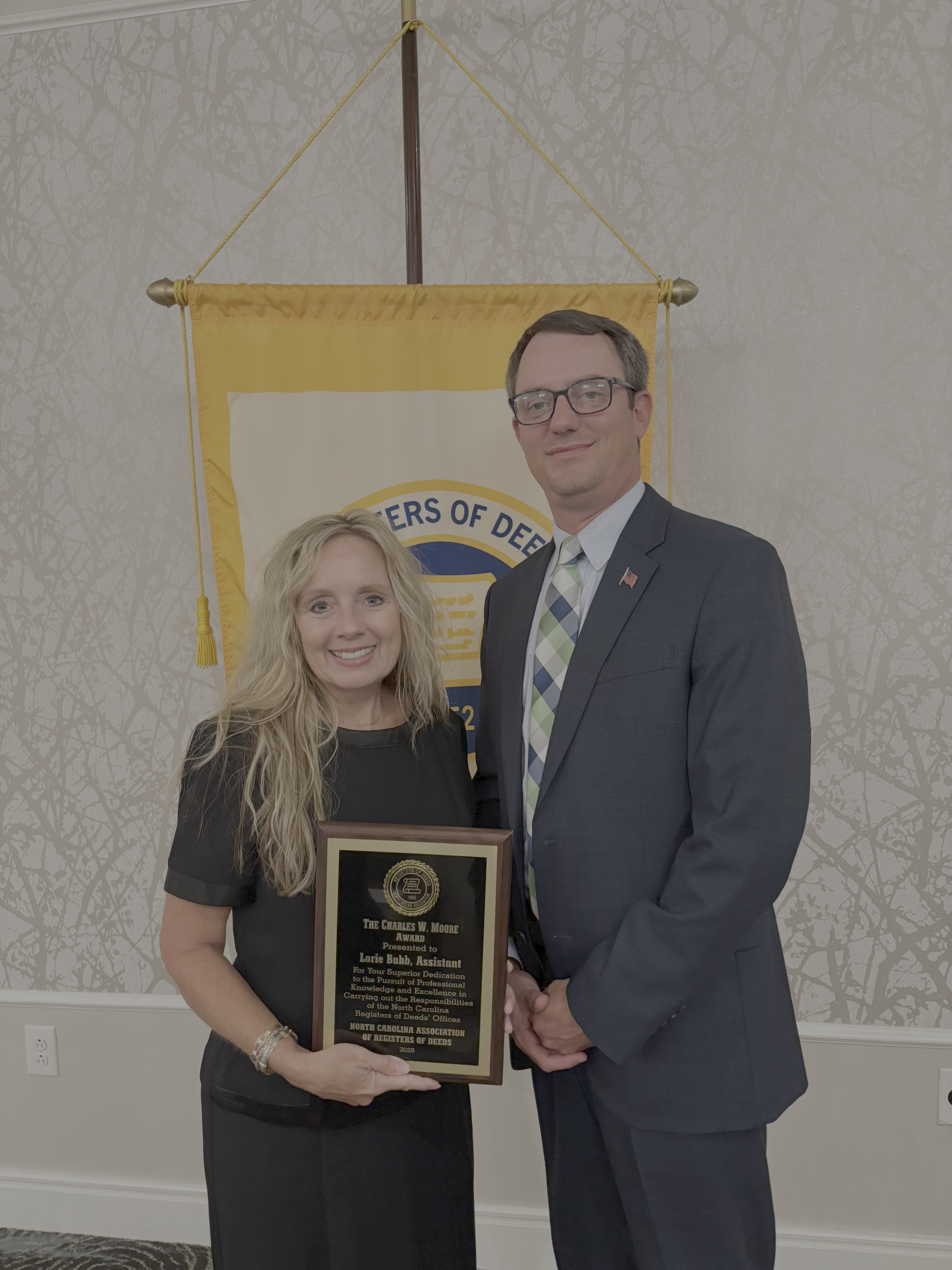 Image of Lori and Matthew holding an award.